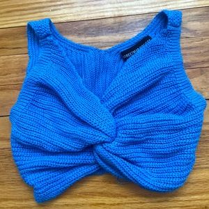 Bright blue crop top with twist in front.